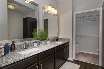 a bathroom with a large mirror and two sinks  at Watermark on Twenty Mile, Colorado
